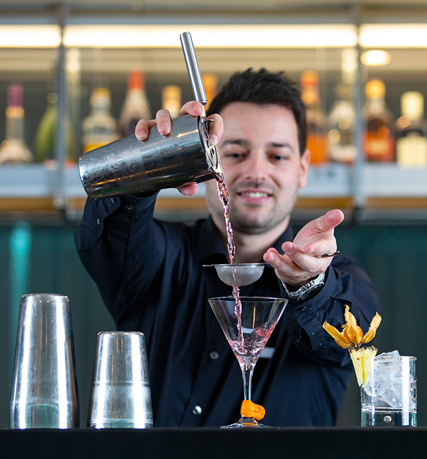 A bartender making cocktails in the Panorama Lounge and Bar
