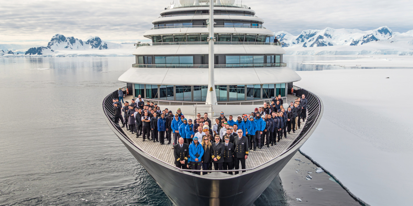 The crew of Scenic Eclipse standing together on the dec, enjoying the view and the fresh air of the Arctic.