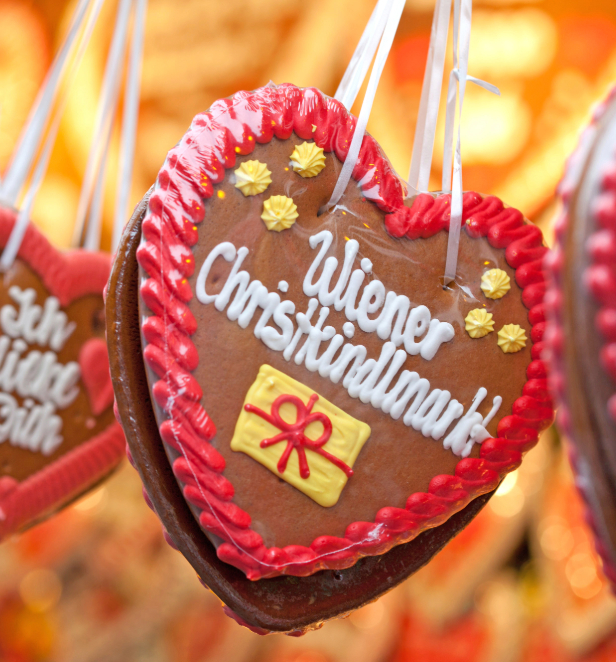 A selection of German gingerbread hearts gracefully hanging from fine strings, creating a whimsical and festive atmosphere.