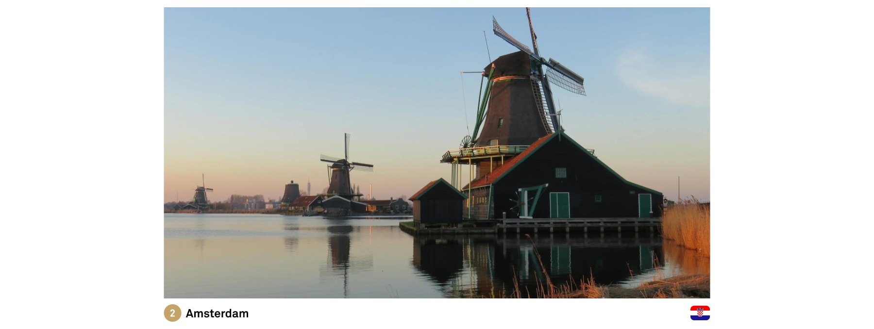 Amsterdam windmills next to a clear lake