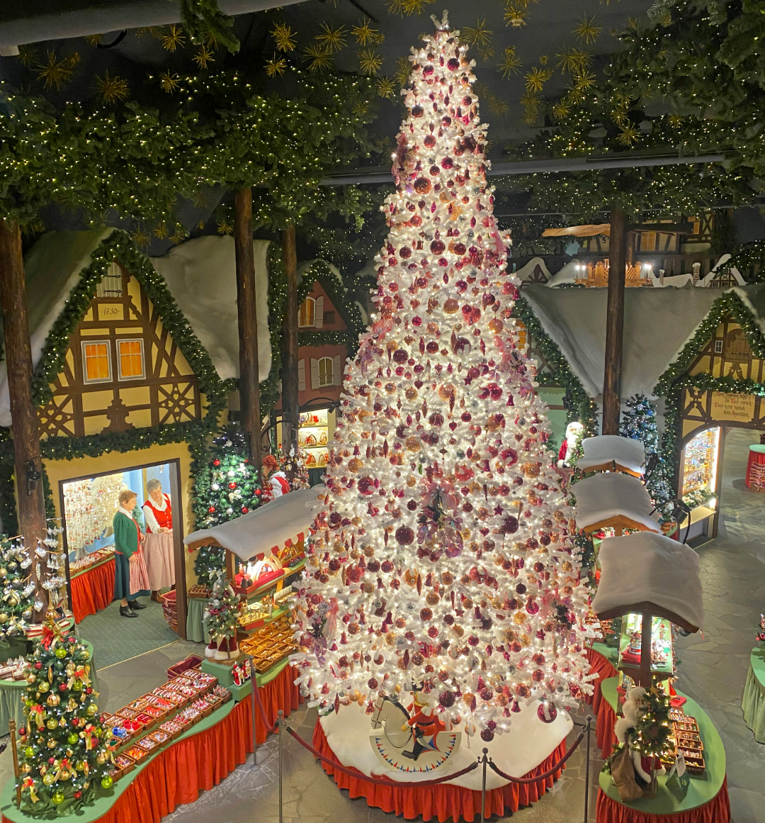 Large christmas tree surrounded by Christmas market stalls