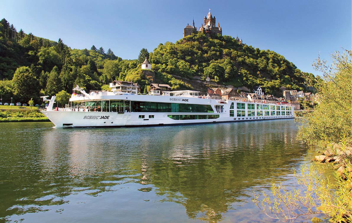 luxury river cruise ship sailing down a river in front of the Reichsburg Castle