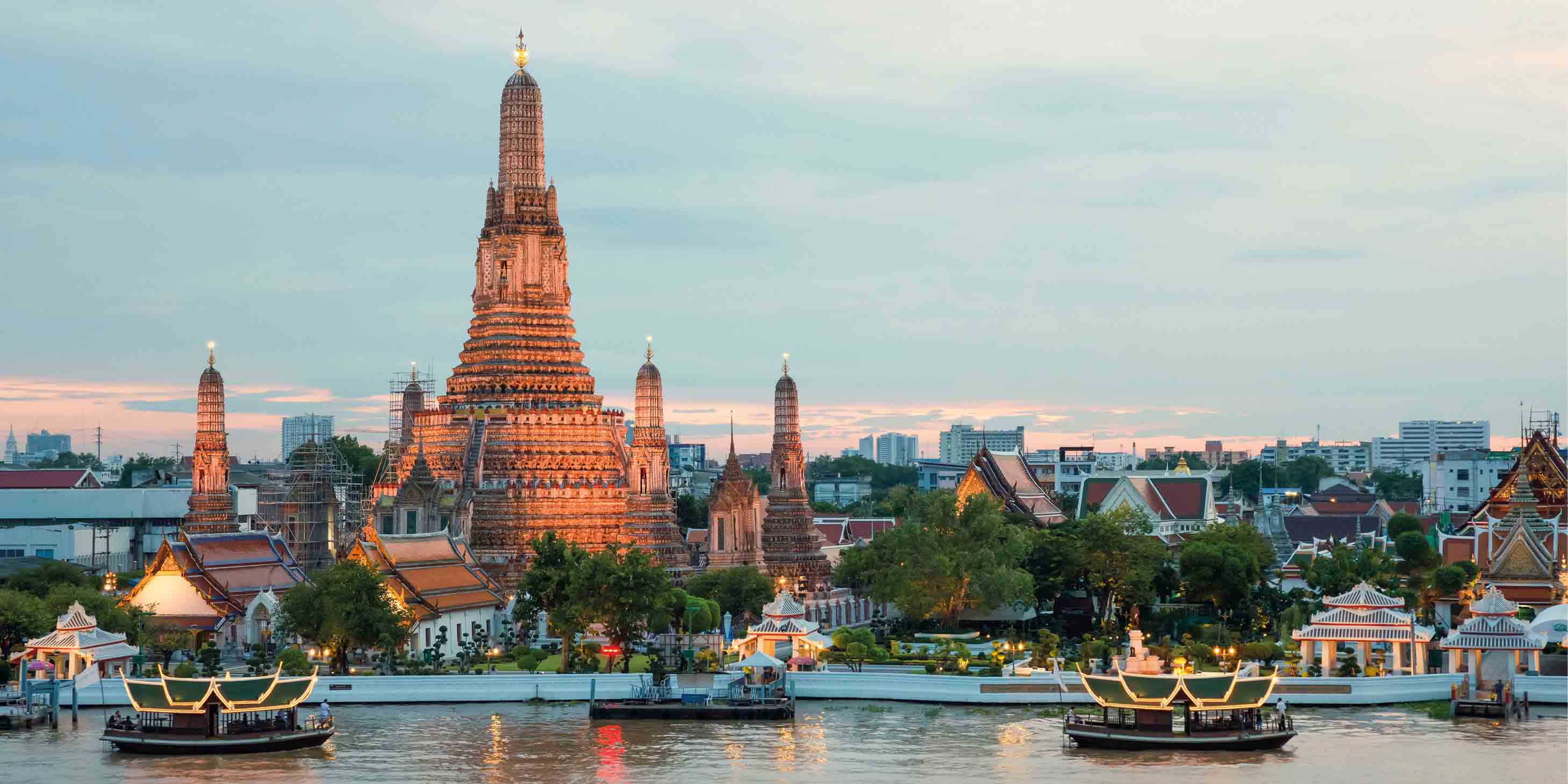 Bangkok by the water, Wat Arun temple lit up at sunset.