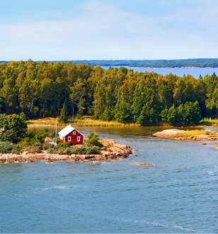 Small red house surrounded by a lake