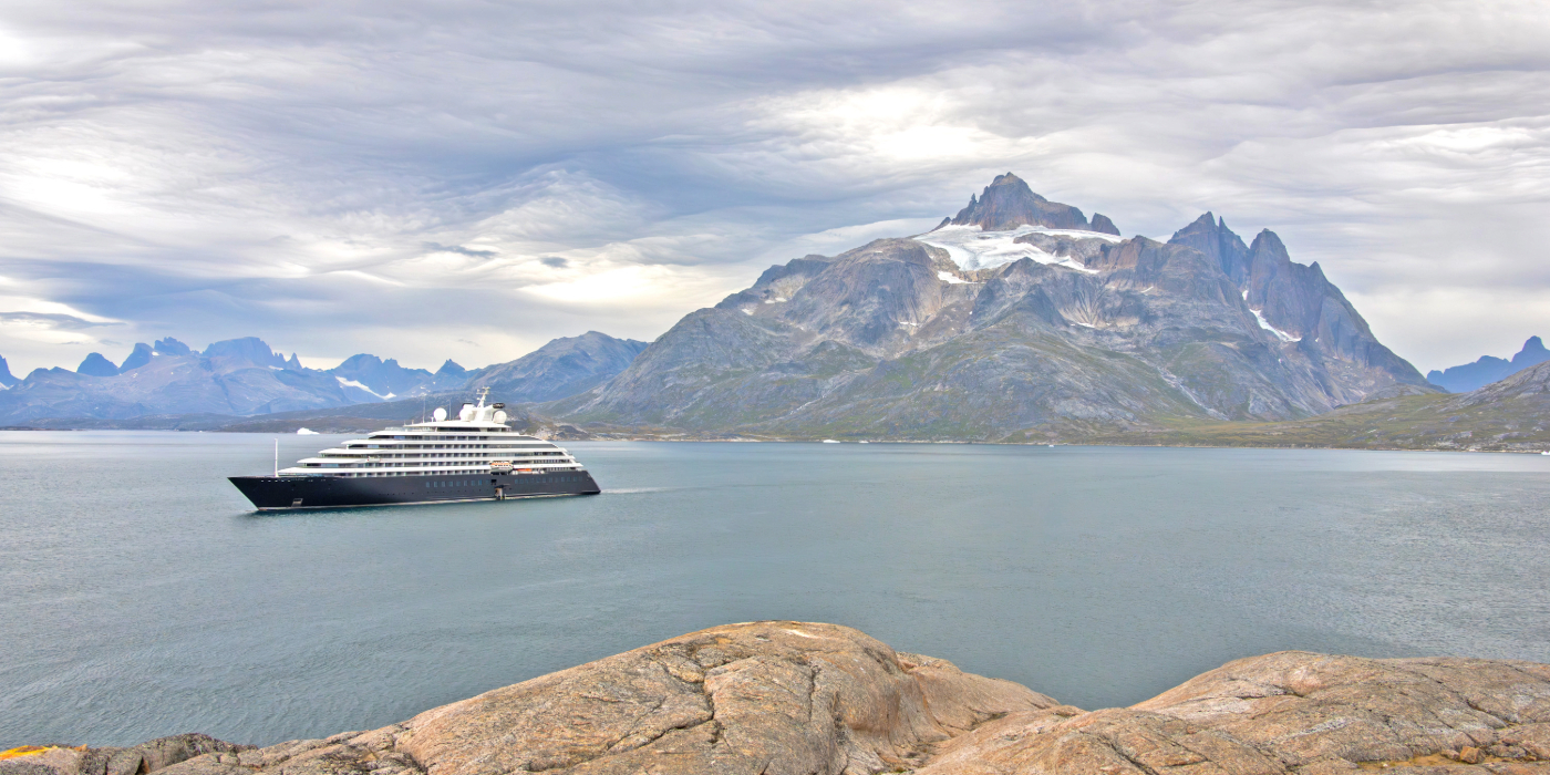 Scenic Discovery Yacht in Icelandic waters with a mountain in the back drop