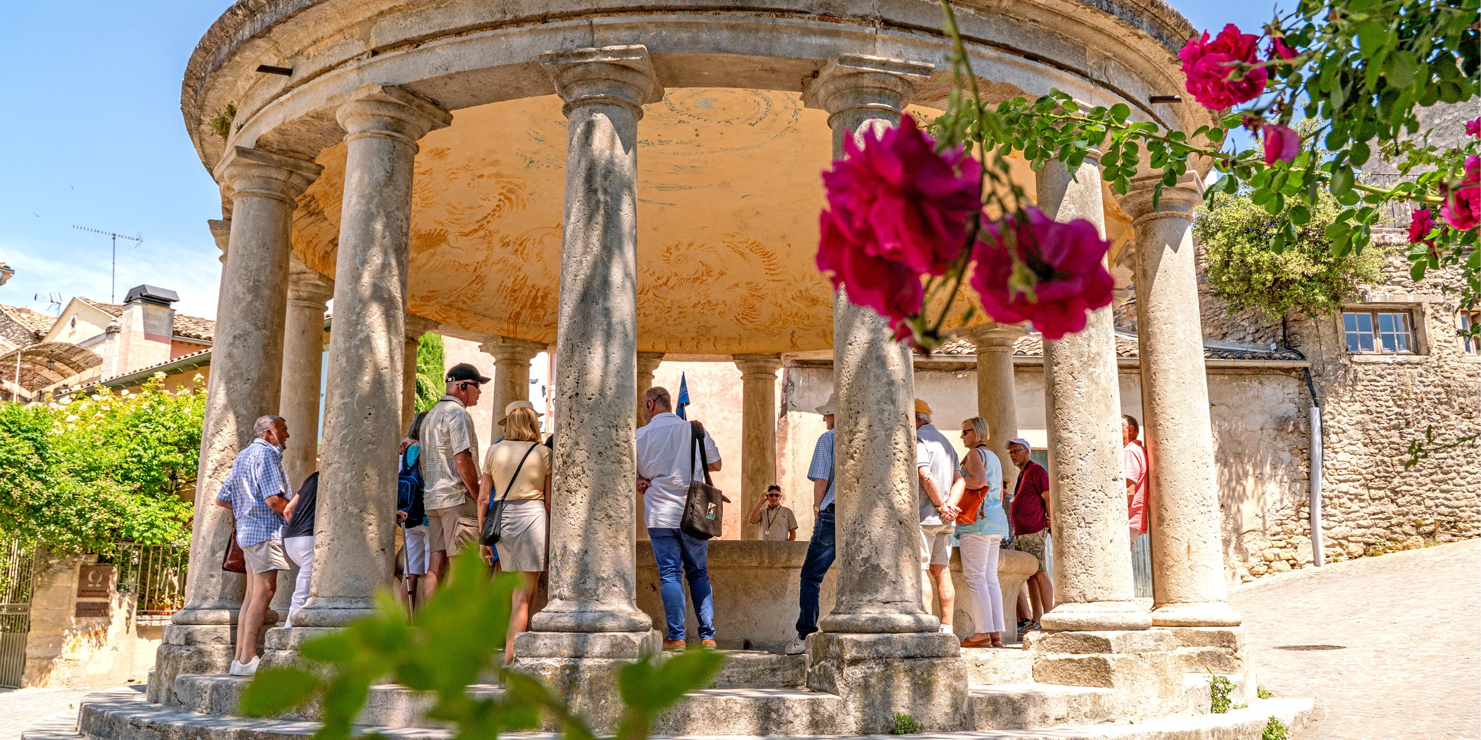 Group of tourists walking around an ancient ruin