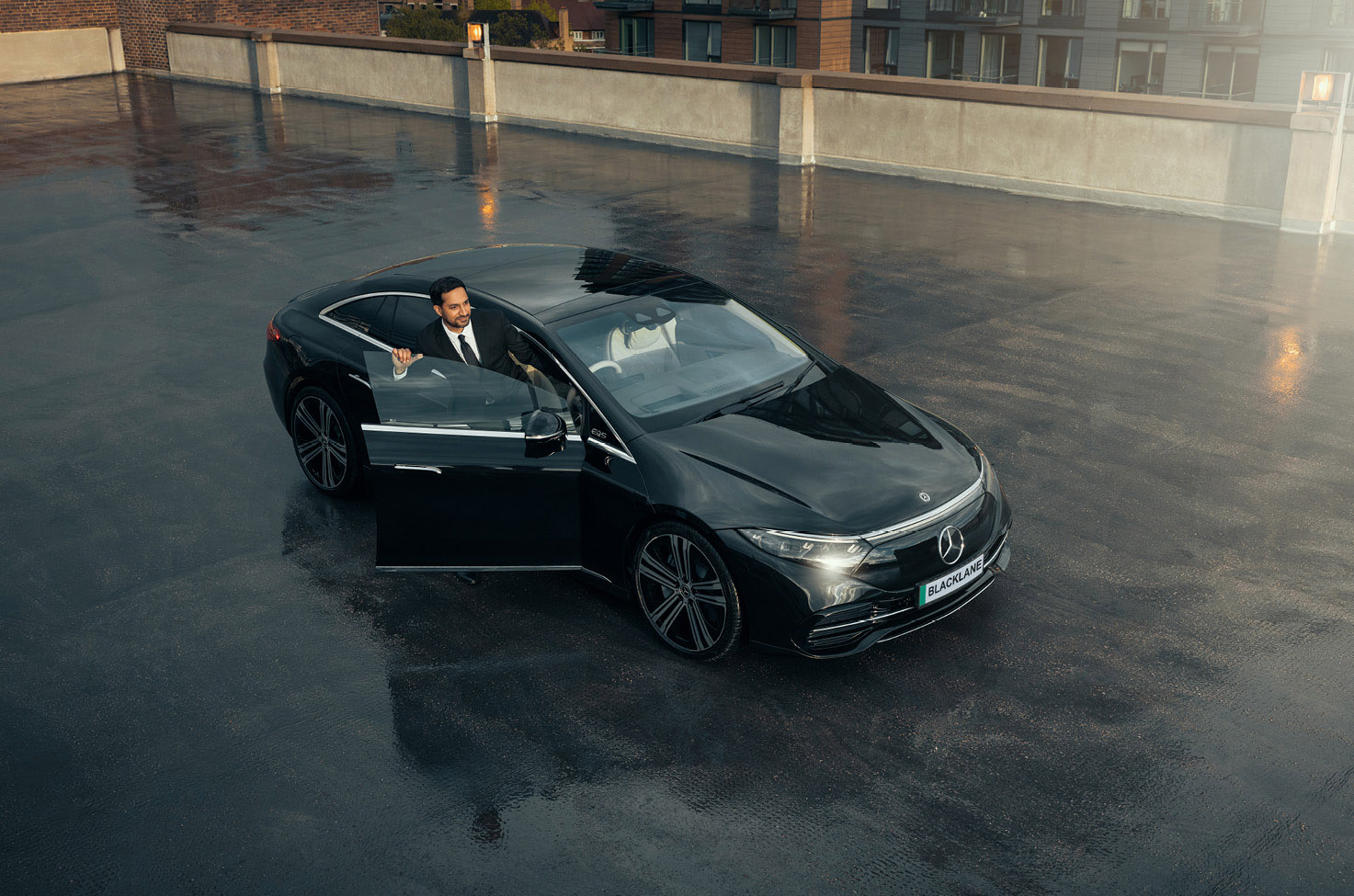 Blacklane Private Chauffeur Service driver getting into black luxury sedan vehicle